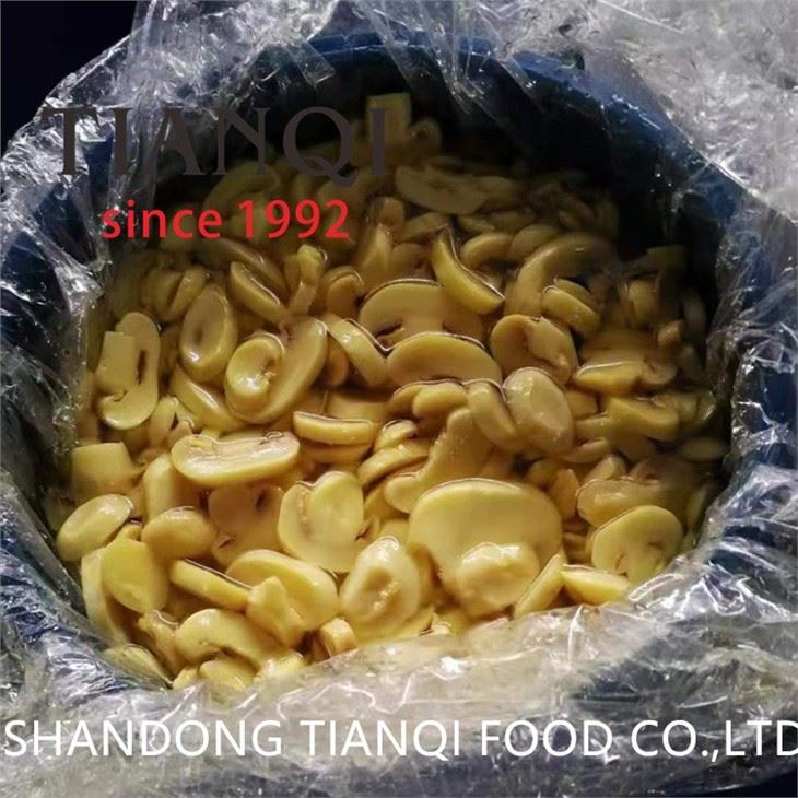 Cultivated white sliced  mushroom in plastic drums