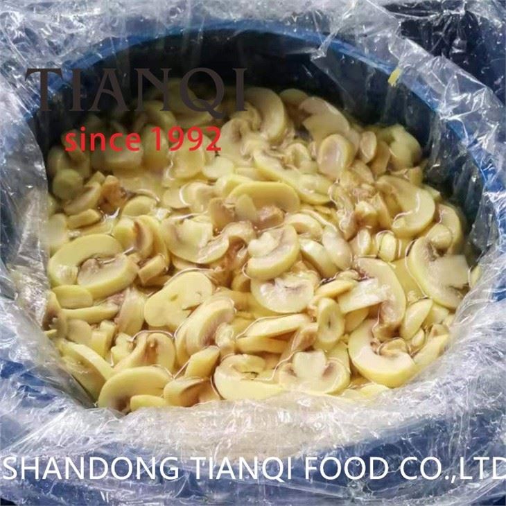 Pickled cultivated champignon mushroom in drums